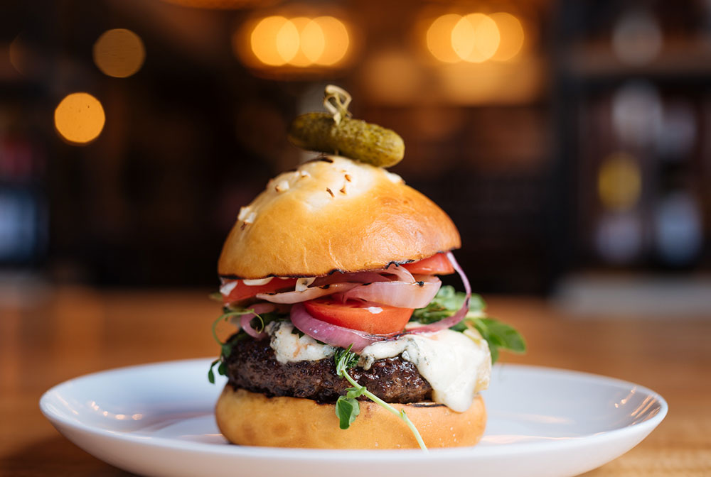 HOUSE-GROUND BURGER Ground Hanger Steak, Greens, Tomato, Grilled Onion, Truffle Aioli Choice of Blue Cheese or Cheddar